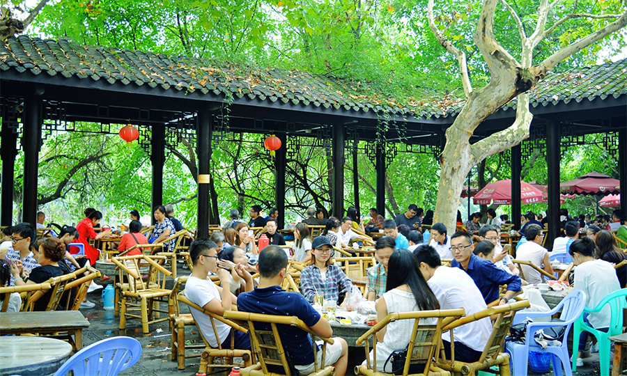 Local people enjoying tea at a traditional teahouse in Chengdu People's Park