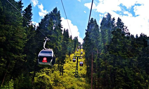 Taking the cable cars will take you to the peak of Huanglong Scenic site