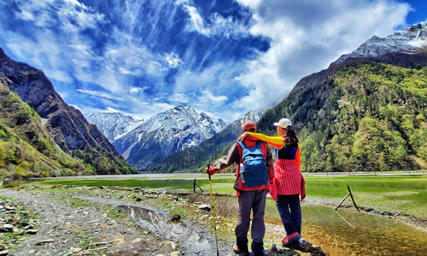 Hikers enjoying mountain views in Haizi Valley, Mount Siguniang
