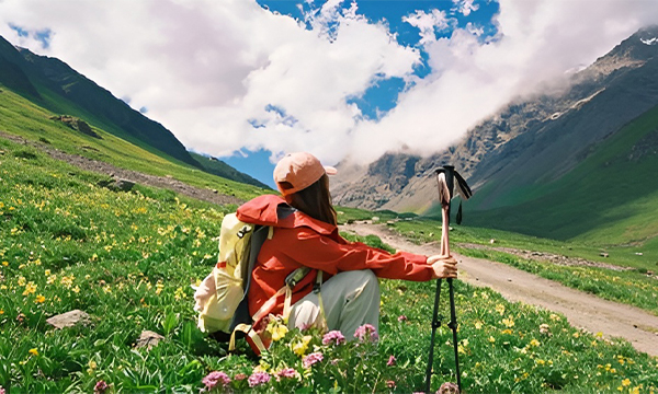 Hiker walking through alpine meadows in Sichuan