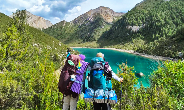 Travelers hiking in Qizanggou near Songpan