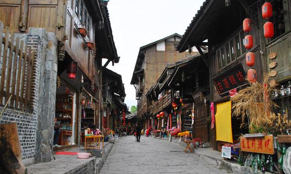 Newly built hotels, restaurants, shops, and inns line the now-modern street.