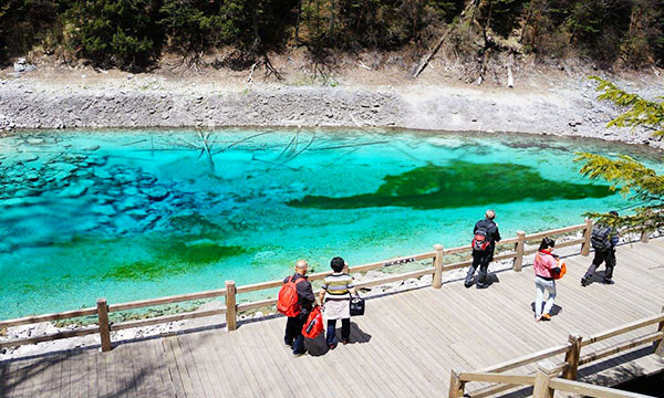 Hiking around colorful lakes in Jiuzhaigou National Park.