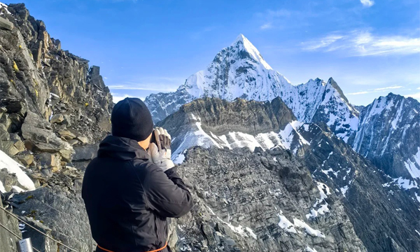 Hiker wearing layered clothing for Siguniangshan trekking in Sichuan
