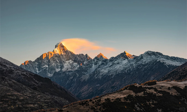 Golden sunrise over snow mountains in western Sichuan