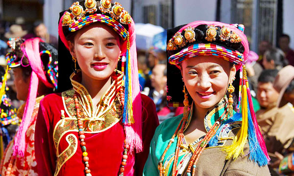 Many colors and beads sewn onto women’s clothes.